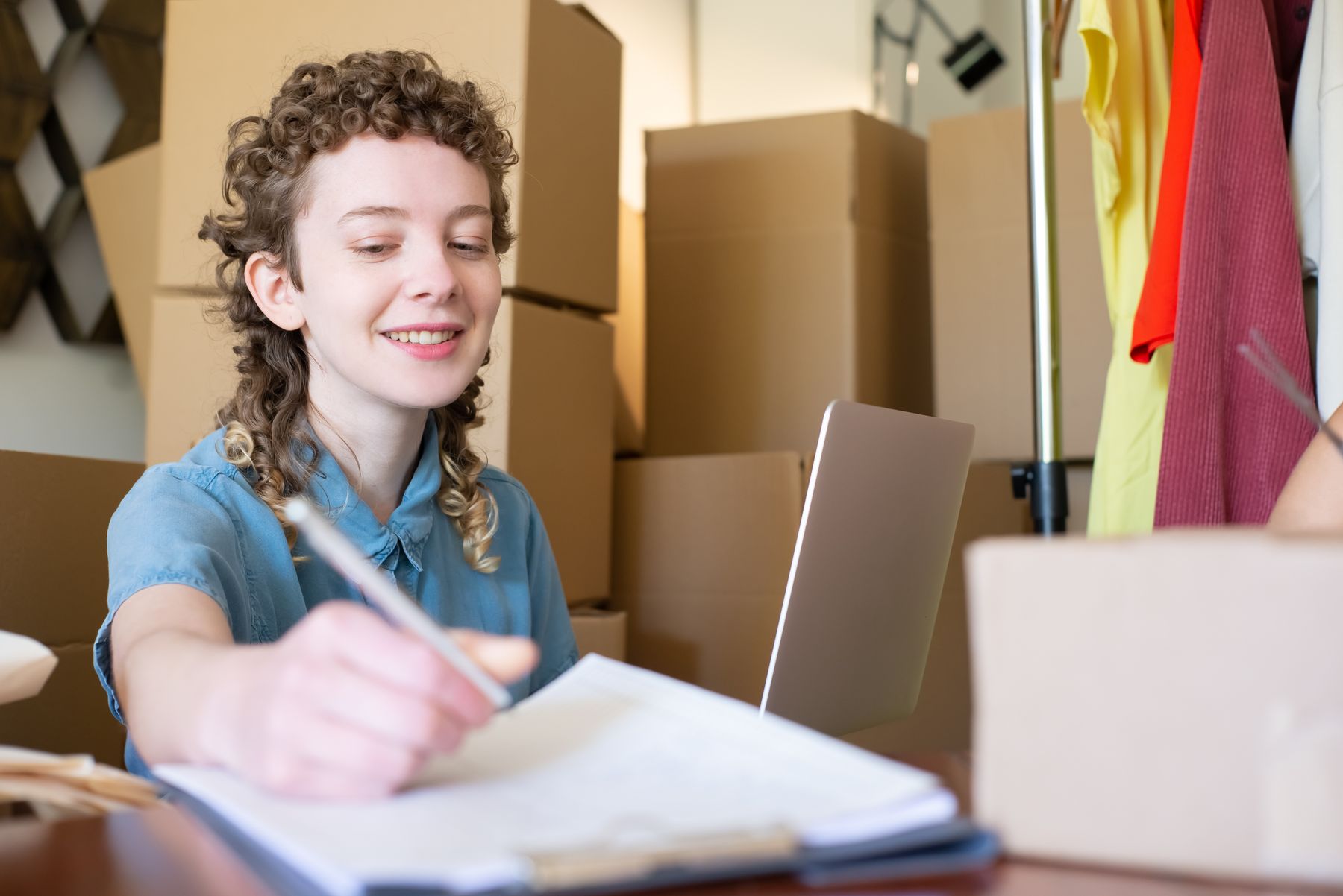 SBA Express Loans: How to Get Up to $500,000 Faster 2 Small business owner packing orders with a laptop, funded by an SBA Express loan