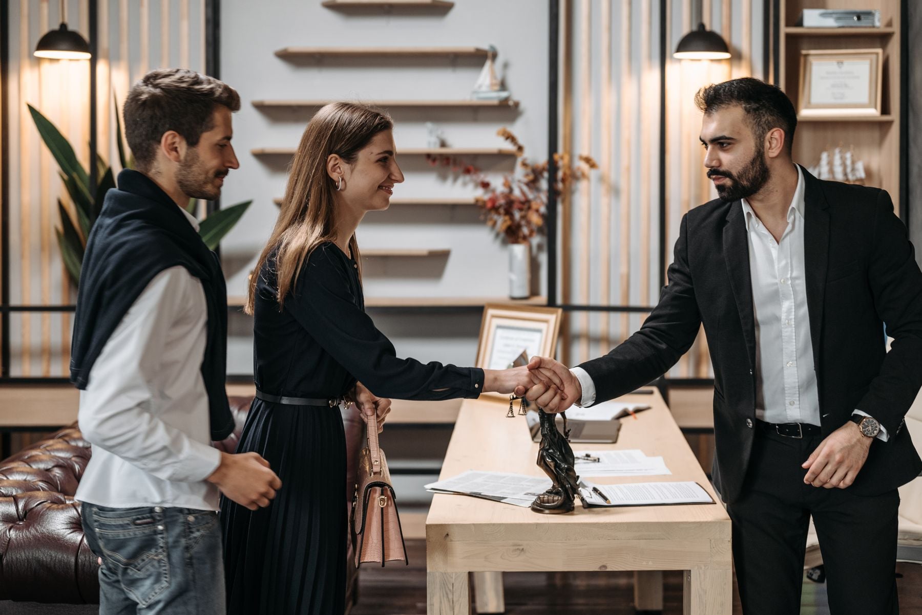 SBA Loans 2 Business owners shaking hands with a lender in a modern office