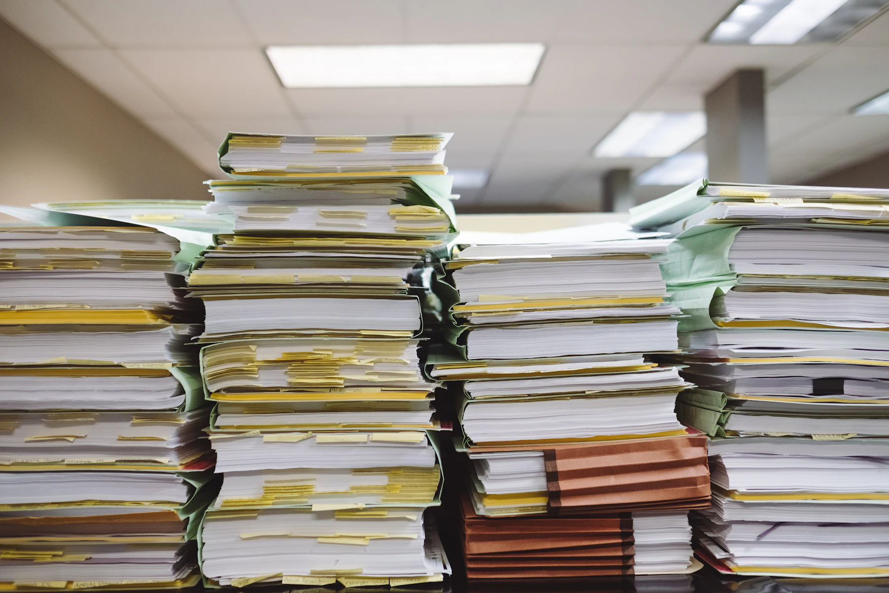 Second Position Merchant Cash Advance 2 Stacks of paper documents and file folders