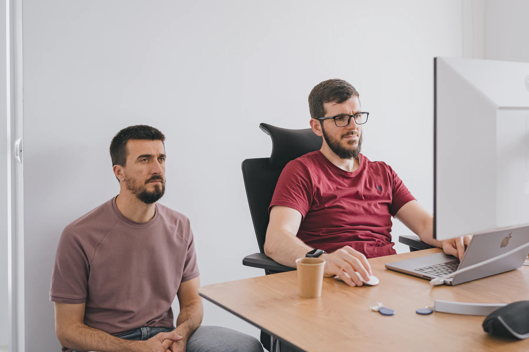 Software Company Business Loans: Hiring, Growth and Acquisition Financing Without Dilution 2 Two men sitting at a table with a laptop