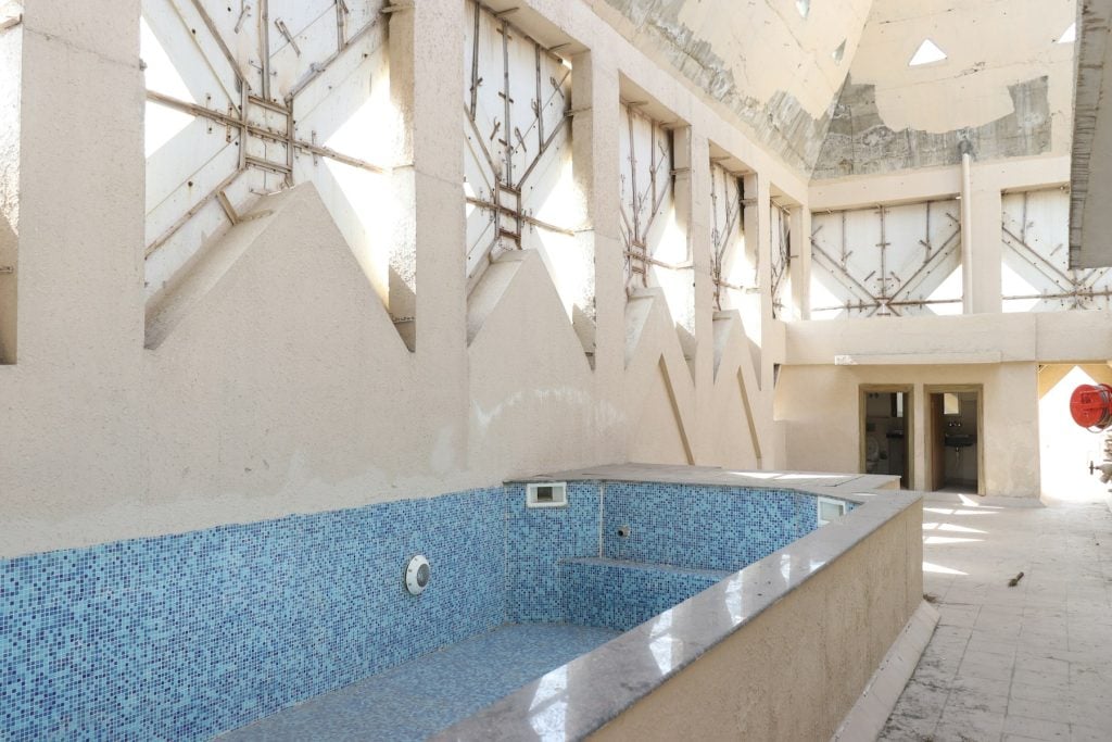 Empty tiled swimming pool under construction