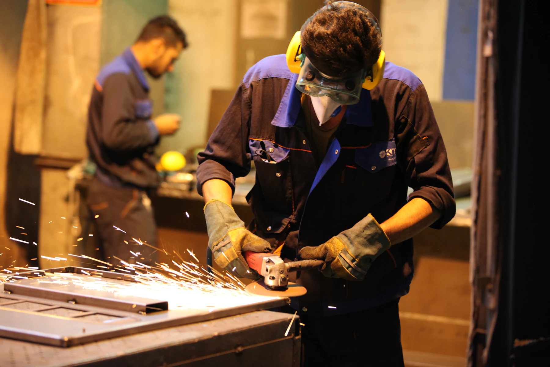Types of Fast Business Loans: 6 Fastest Options Compared 2 Metalworker grinding steel with sparks in a workshop