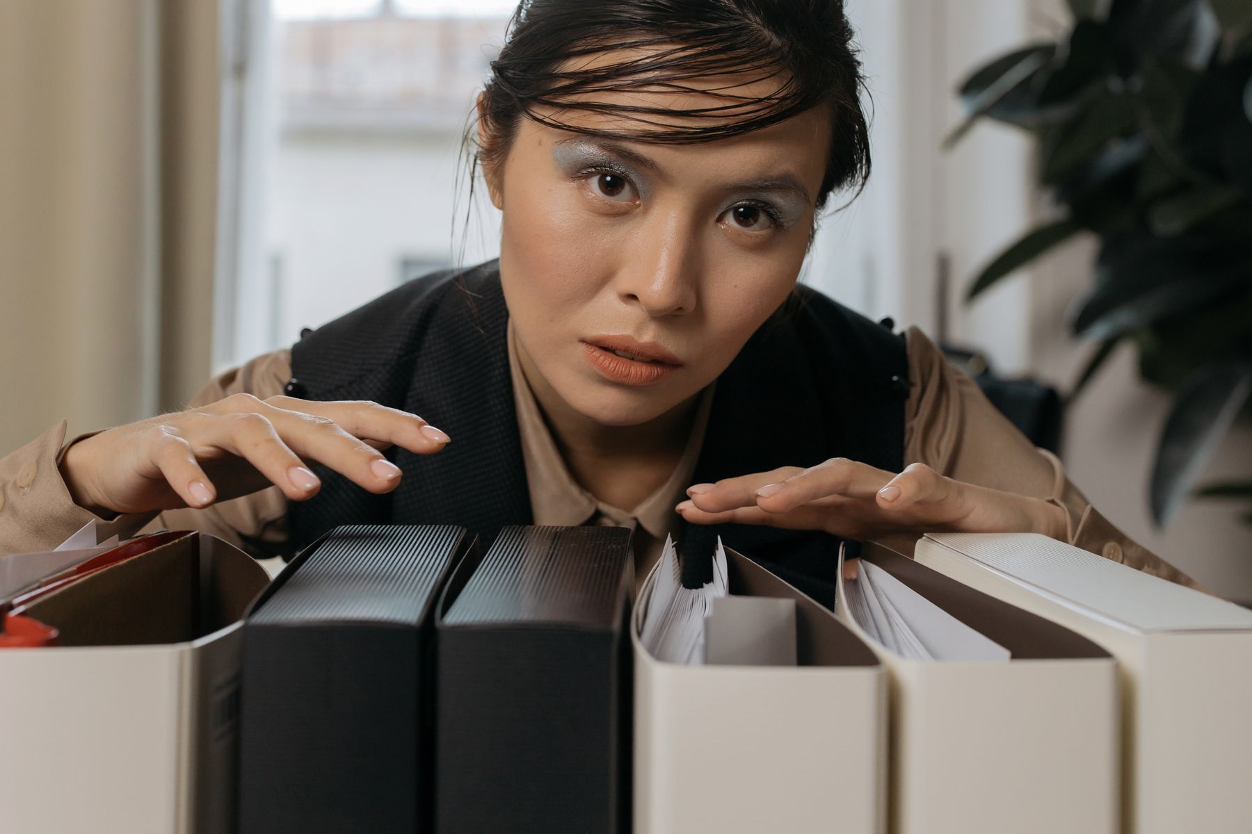 What Documents Do I Need to Apply for a Business Loan? 2 Business owner pulling binders and files from an office shelf