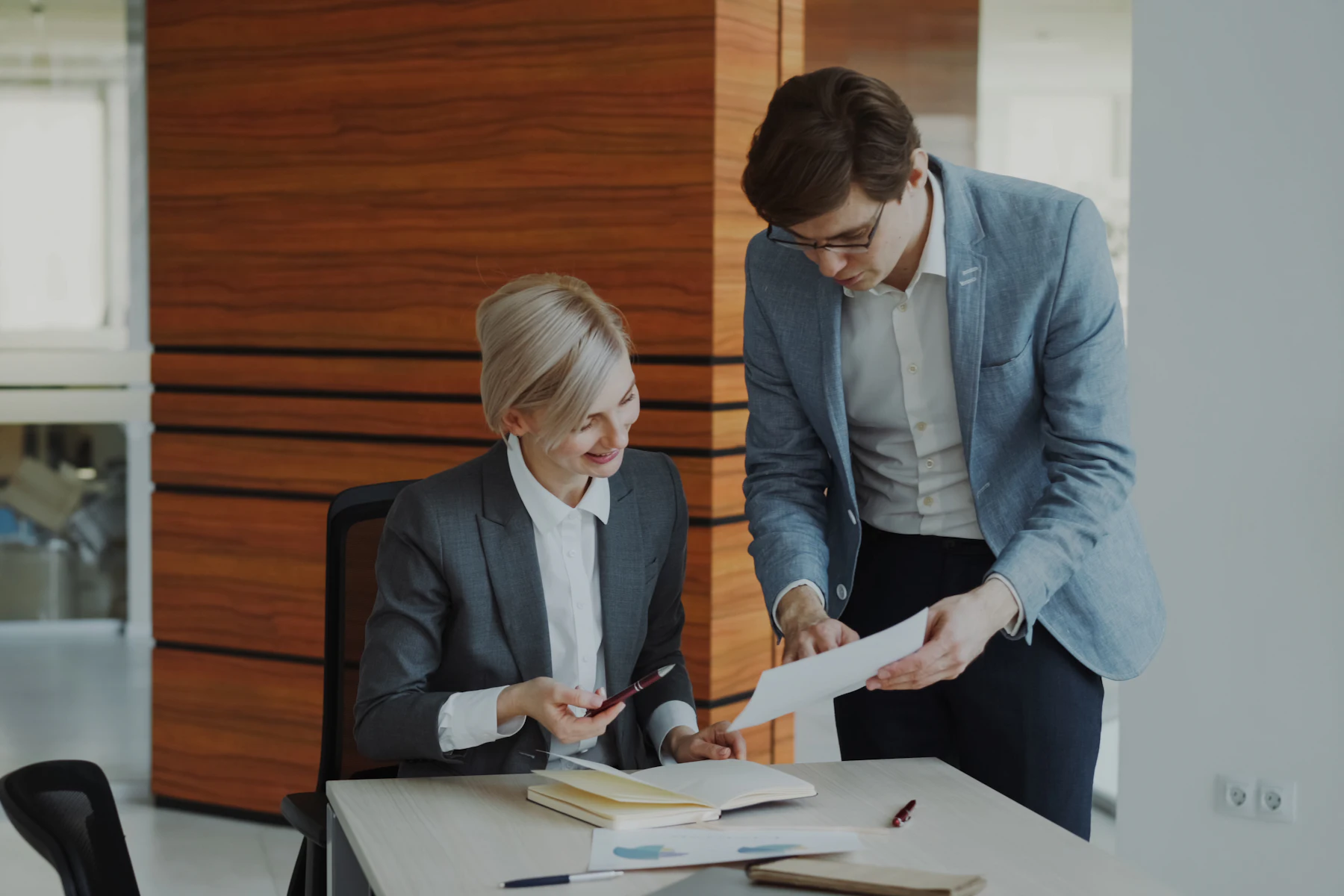 What Is a Business Loan? A Plain-English Definition 2 Two colleagues reviewing loan documents at an office desk