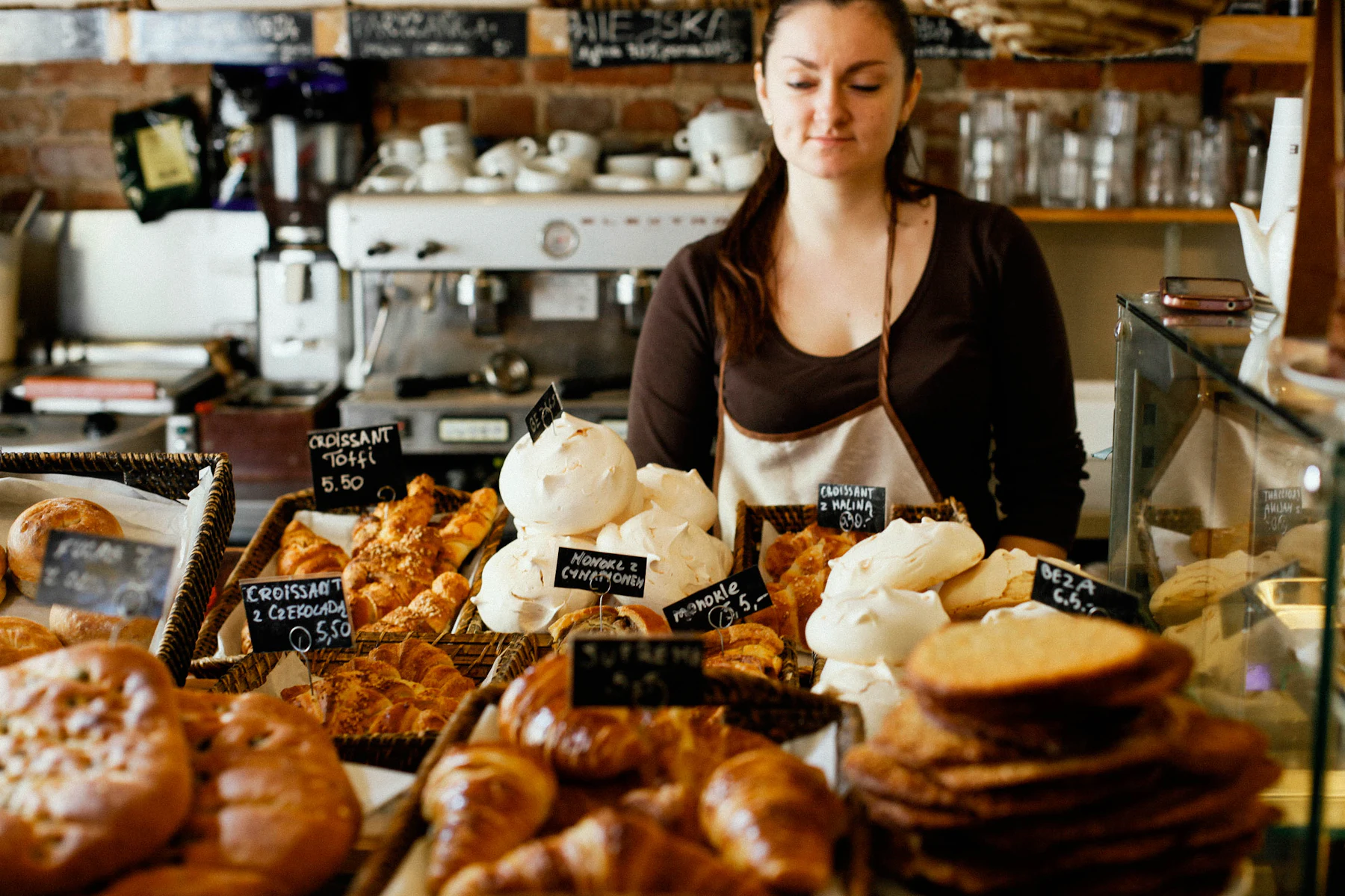 What Is Working Capital? A Plain-English Guide for Business Owners 2 Woman at a counter near loaves of bread